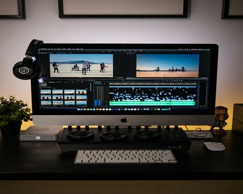Neat desk setup with a computer showing video editing timeline
